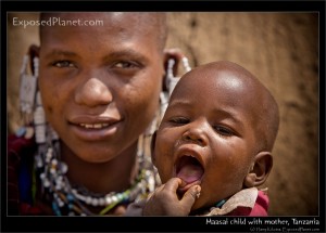 Maasai child with mother, Tanzania. (c) Harry Kikstra, ExposedPlanet.com