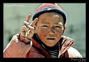 Tibetan kid showing peace sign. (c) Harry Kikstra, ExposedPlanet.com