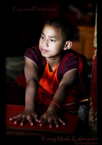 Young monk in Nepal waiting for his turn to bang the drum. (c) Harry Kikstra, ExposedPlanet.com